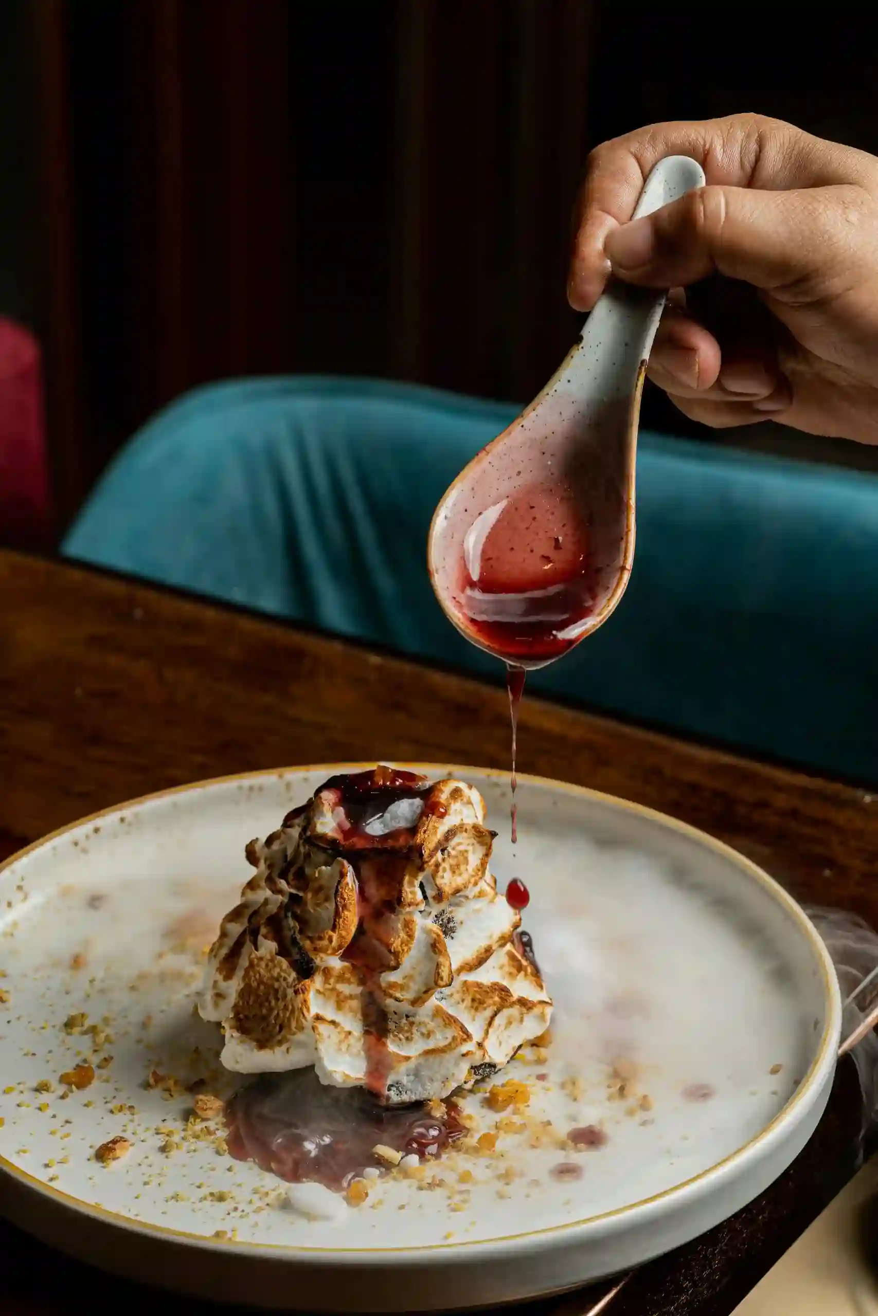 Delicious gourmet dessert topped with fresh berry sauce, adding a burst of flavor and color.