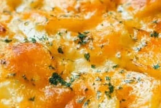 Delicious easy cheesy potato casserole served in a baking dish.